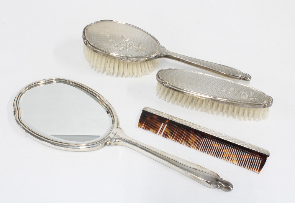 A silver backed dressing table brush set, Birmingham 1960, coorising hand mirror, hair brush,