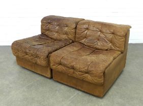 A pair of vintage tan leather patchwork chairs, likely by De Sede, with clips to make a two