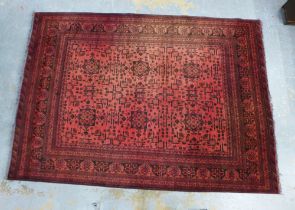 An Afghan Khan Mohamadi rug, red field with eight flowerhead panels within geometric borders, ,