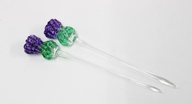 Two coloured art glass swizzle sticks, in the form of thistles 14cm (2)