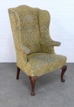 An Upholstered high back wing back armchair in the Georgian style, 129 x 50cm.