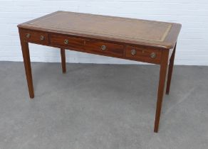Early 20th century mahogany desk, with tan leather skiver, three drawers and raised on tapering