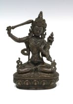 Bronze patinated Buddhist figure of Tara, sitting cross legged on a lotus base, 21 x 14cm.