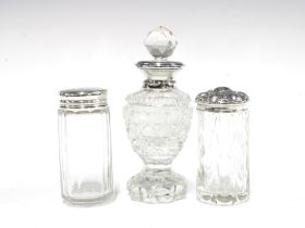Two silver topped glass jars and a silver collared glass scent bottle with stopper, London 1927,