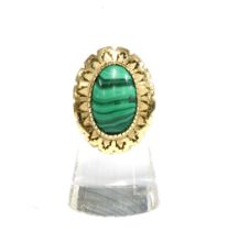 Polished malachite cabochon dress ring in an unmarked yellow metal surround on an unmarked band