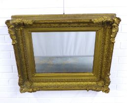 An ornate gilt frame with rectangular mirror glass plate, 84 x 72cm.