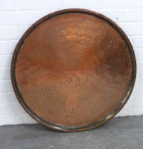 Cairo copper tray, circular outline with engraved patter, 69cm.