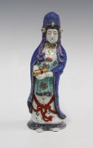 Arita figure of Kannon, modelled standing wearing a powder blue cloak, 20cm high.