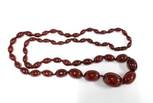 A graduated strand of vintage cherry amber beads, largest bead approx 2.8cm