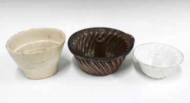 Three early 20th century jelly moulds, 26cm. (3)