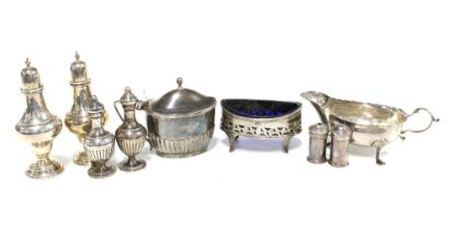 Silver condiments to include pepper pots, salt and mustard, together with a silver sauce boat jug,