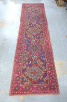 A late 19th / early 20th century turkish type runner of broad proportions, red field with three