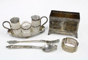 An Edwardian silver stand with three glass and silver mounted condiments Sheffield 1904 together