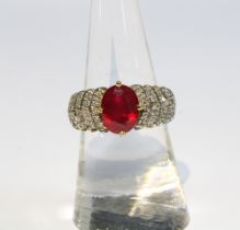 9ct gold ruby and diamond cocktail dress ring by Rocks & Co with an oval claw set ruby flanked by