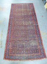 Late 19th / early 20th century North West Persian runner / rug of broad proportions, worn blue field