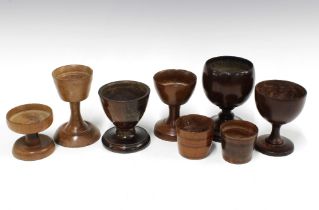 A collection of treen goblets and cups, (8)