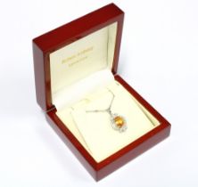 18ct white gold pendant with an orange sapphire within a surround of bright cut & pear shaped