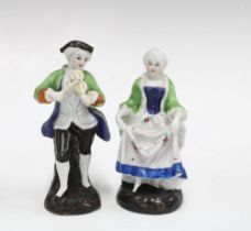 A pair of male and female porcelain figurines (2) 14cm.