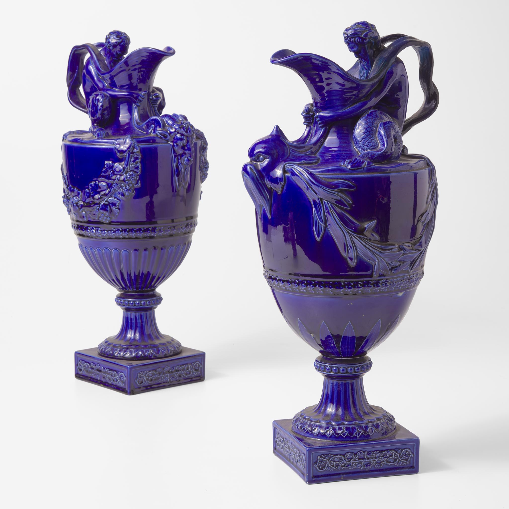 A Pair of Wedgwood Mazarine Blue Majolica-Glazed Water and Wine Ewers UK, 1860s or 1870s