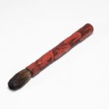 A RED LACQUER CALLIGRAPHY BRUSH WITH 'EIGHT IMMORTALS' DESIGN