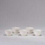 A SET OF FIVE BLANC-DE-CHINE CUPS