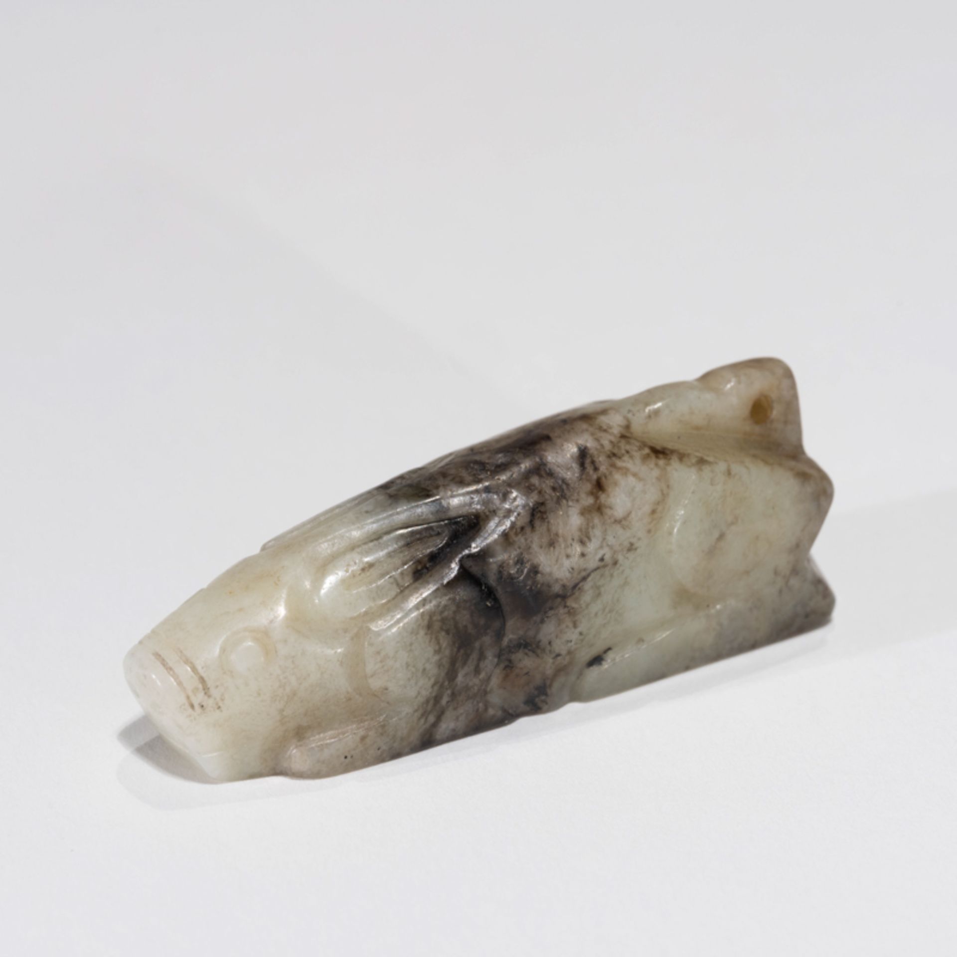 A CHINESE JADE PIG-FORM ORNAMENT