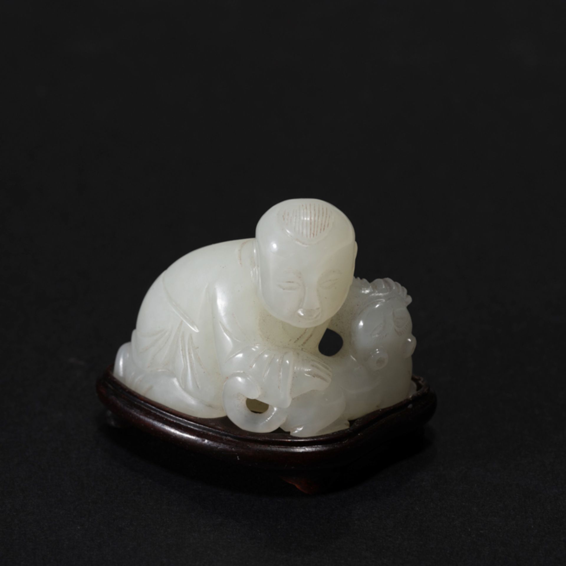 A CHINESE WHITE JADE 'BOY AND TIGER' ORNAMENT