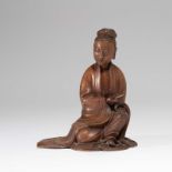 A CHINESE BAMBOO FIGURE OF A SEATED GUANYIN HOLDING A SCROLL