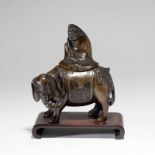 A CHINESE BRONZE INCENSE BURNER IN THE SHAPE OF MAN RIDING AN ELEPHANT
