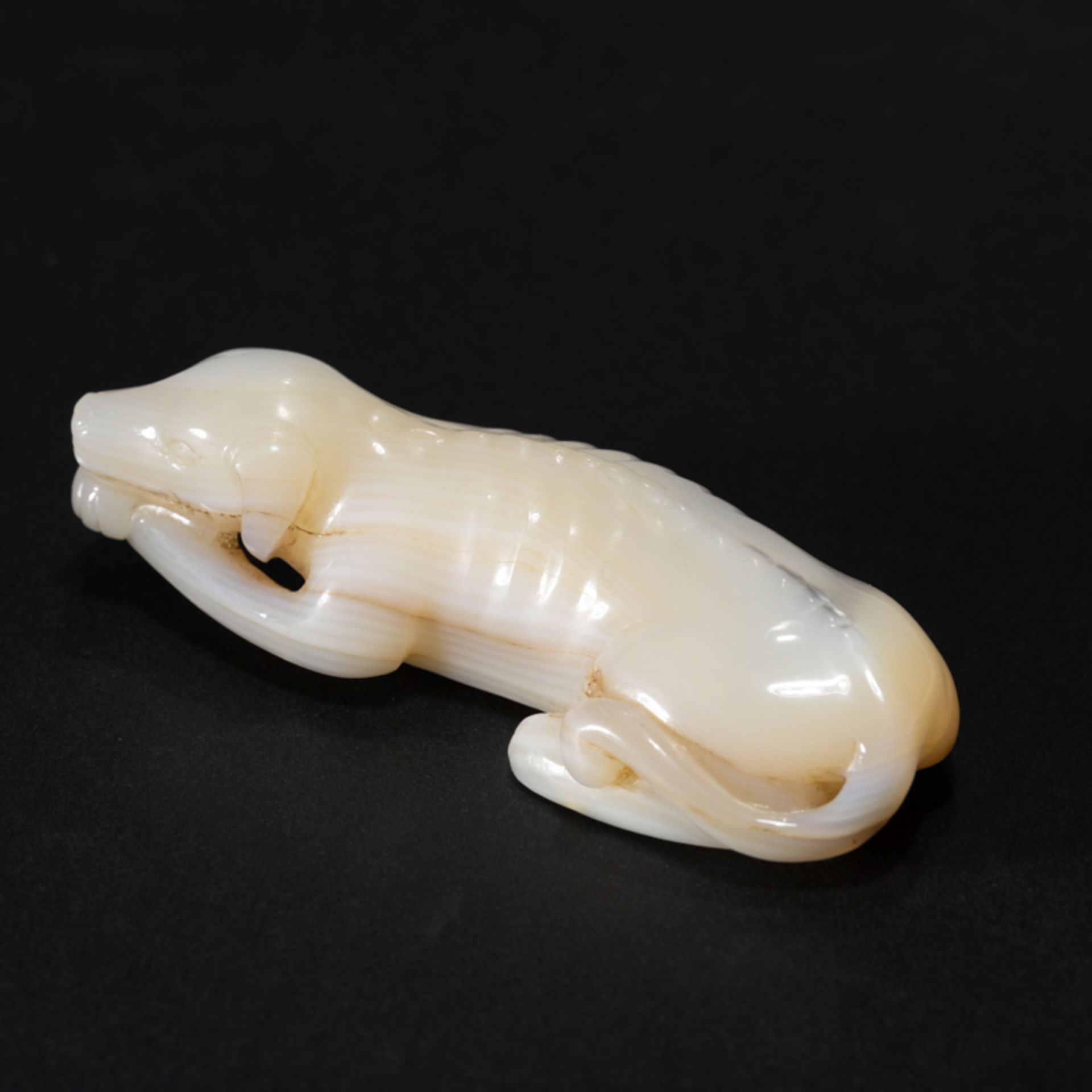 A CHINESE SEASHELL DOG-FORM ORNAMENT