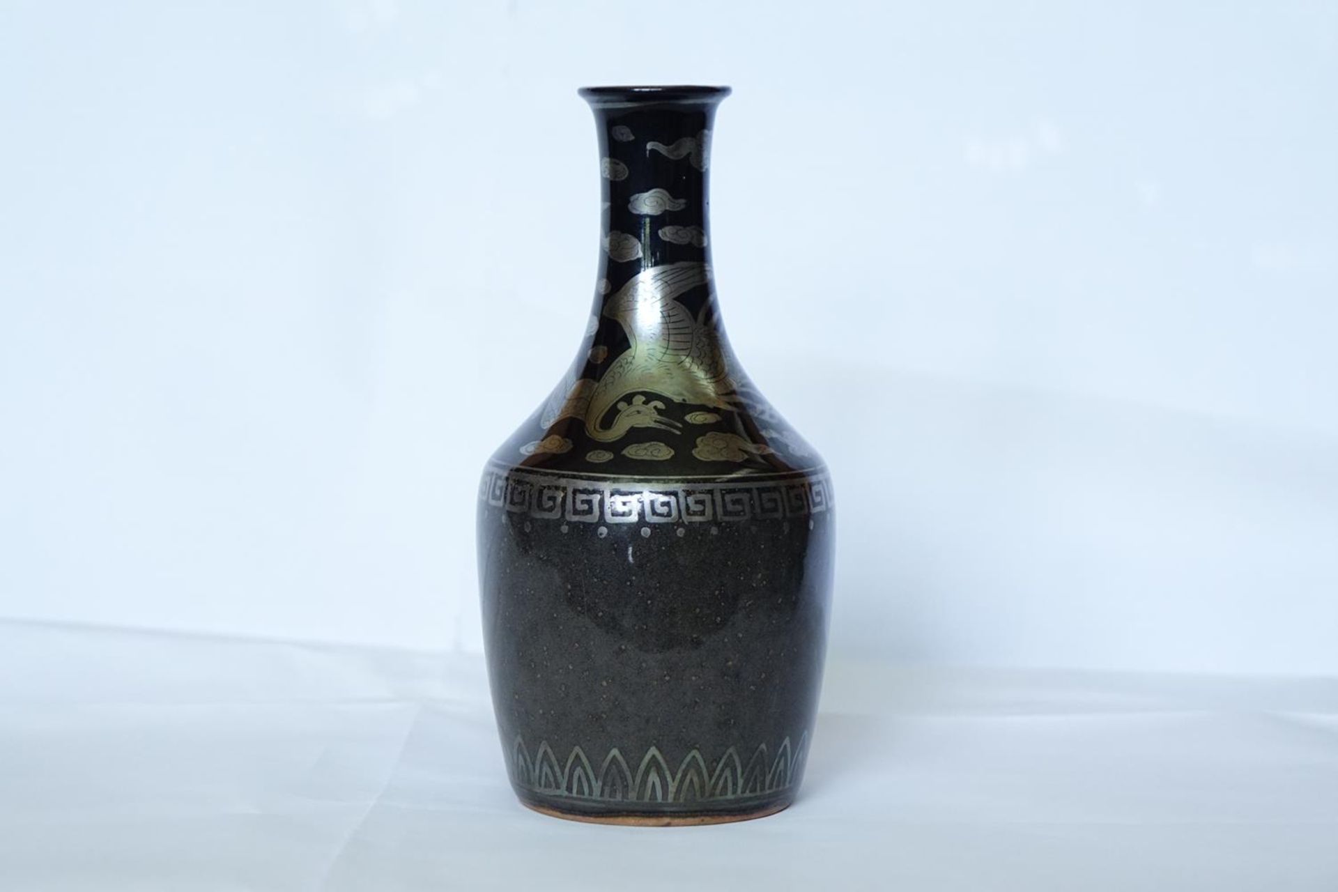 HOZEN: A BLACK GLAZED AND SILVER ENAMELED PORCELAIN VASE