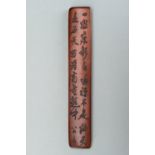 A BAMBOO WRIST REST WITH CALIGRAPHY