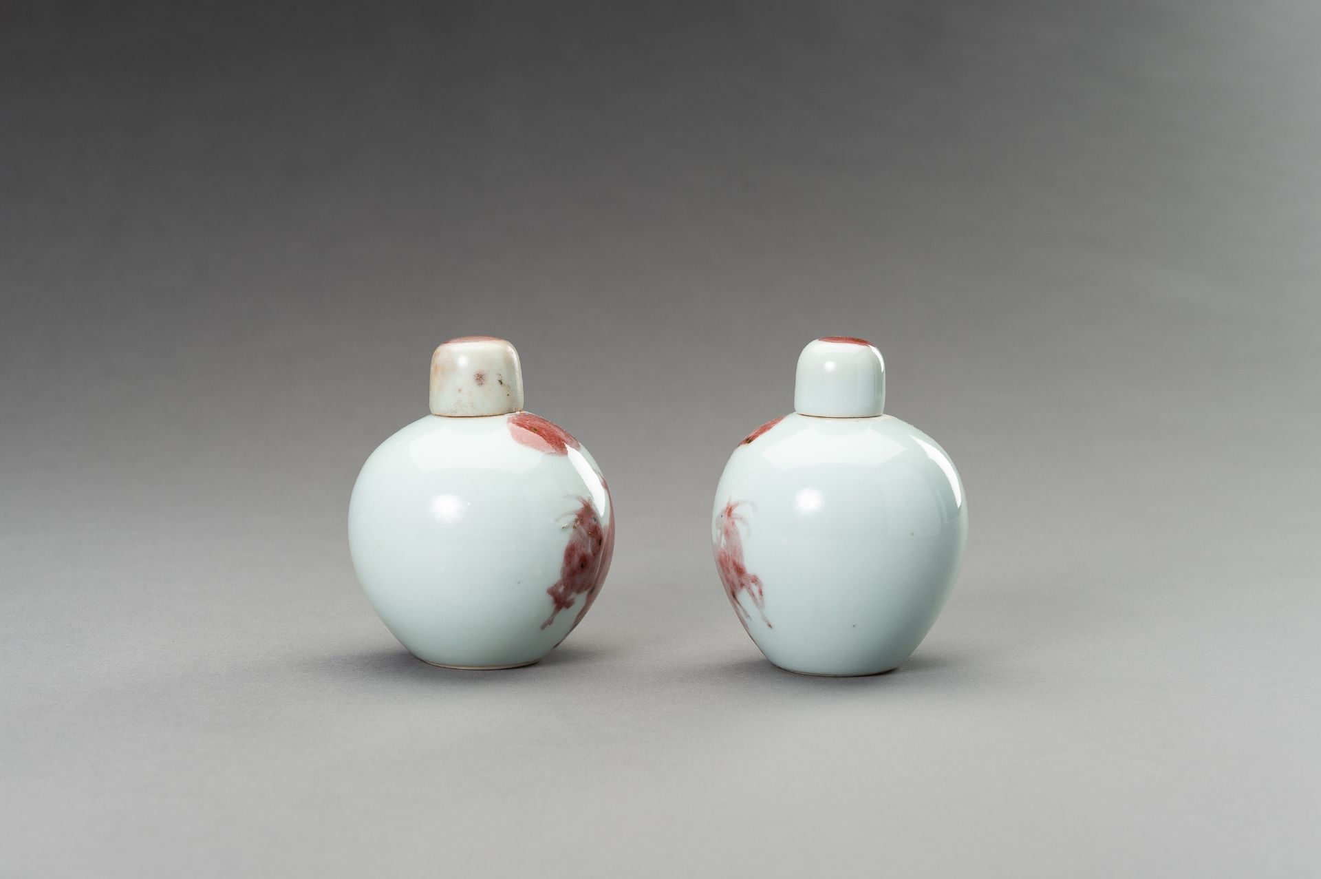 A RARE PAIR OF COPPER-RED, LIDDED PORCELAIN JARLETS DEPICTING GOATS, 1900s - Image 5 of 10