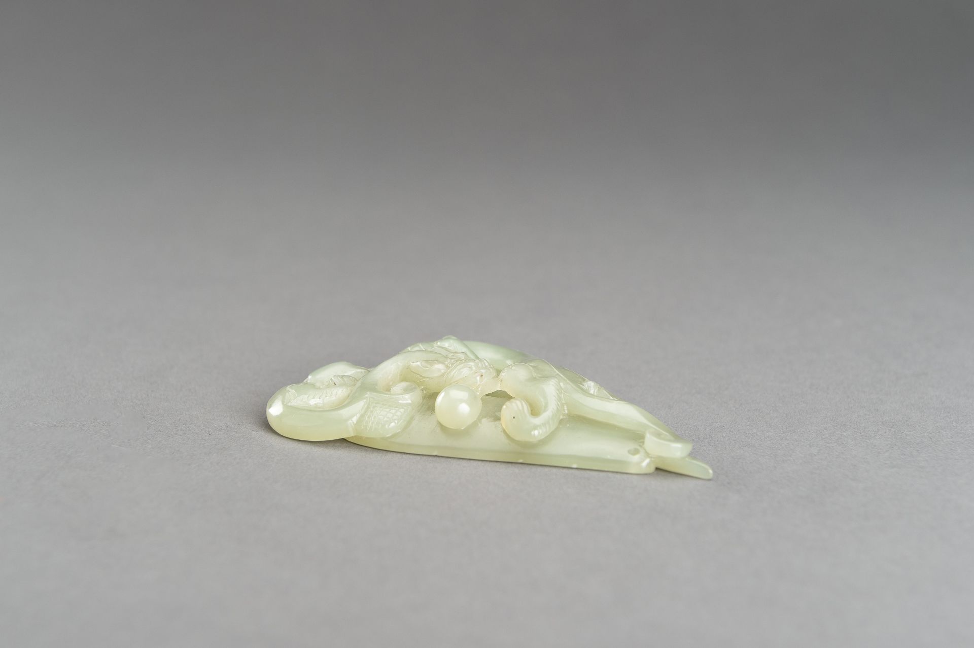 AN ARCHAISTIC PALE CELADON JADE PENDANT OF A CHILONG, 1920s - Image 5 of 14