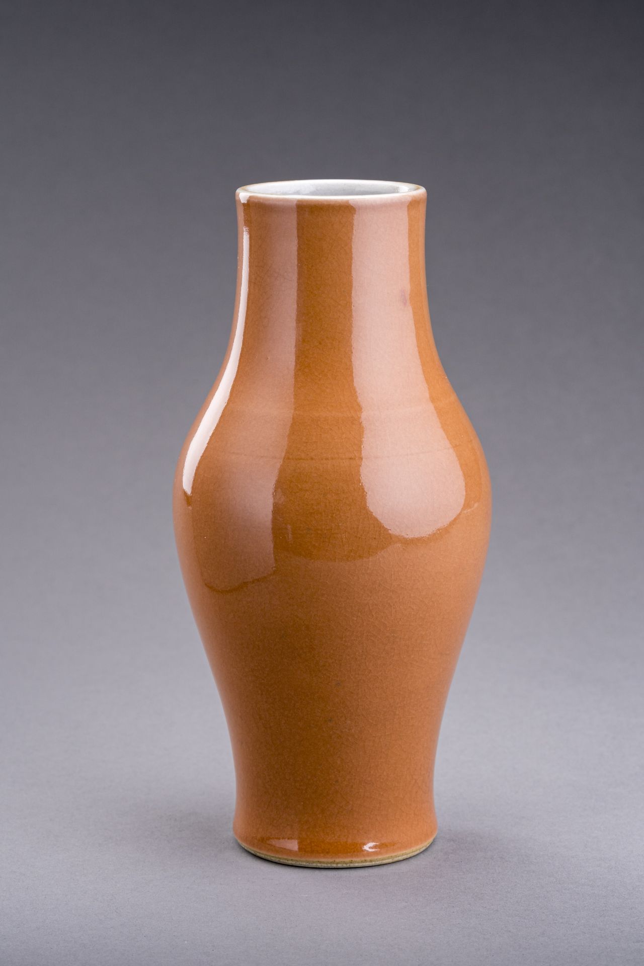 A PALE CORAL GLAZED OLIVE-FORM VASE, QING DYNASTY