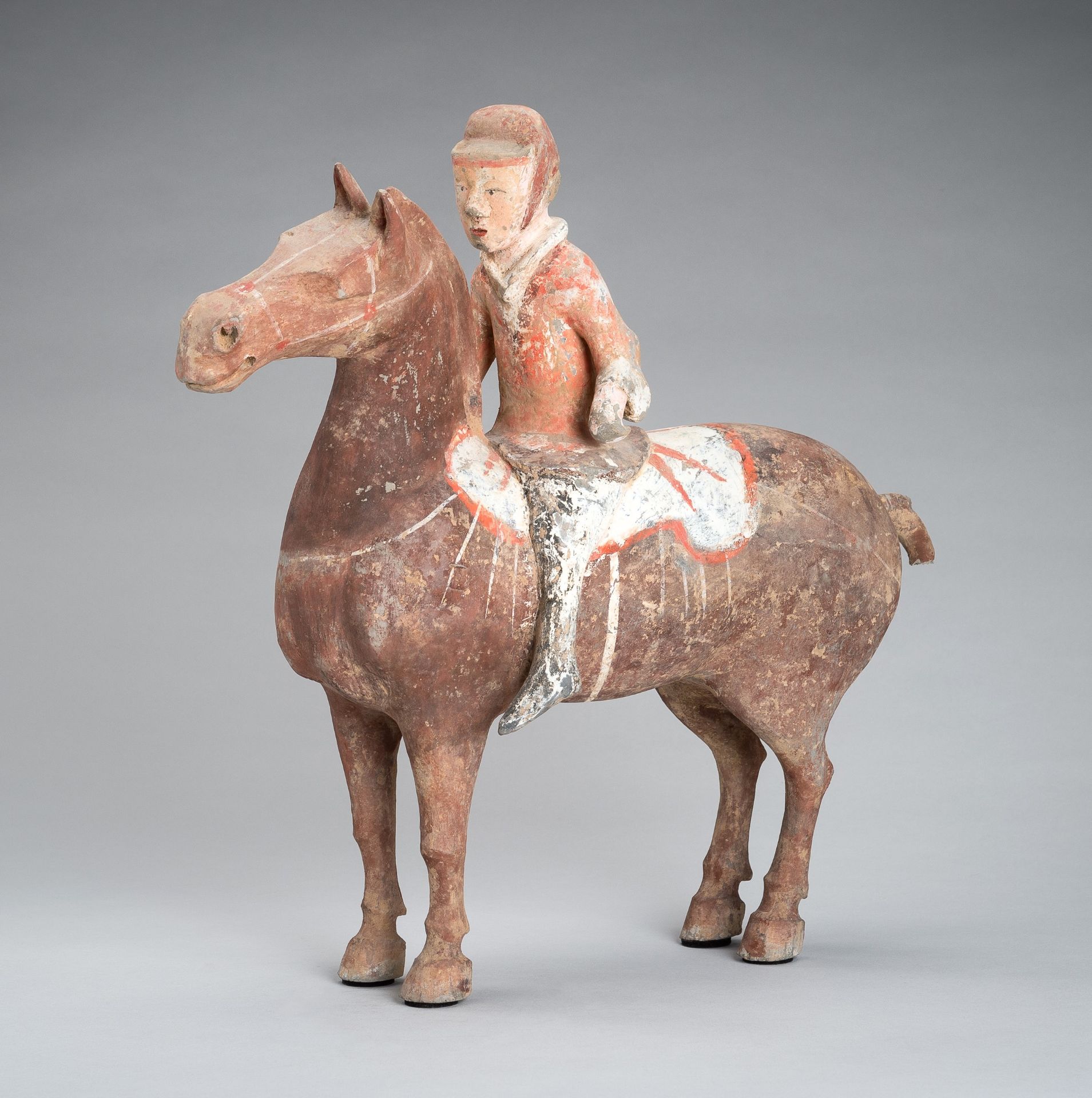 A POTTERY FIGURE OF AN EQUESTRIAN, HAN DYNASTY