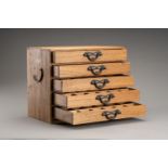 A WOODEN JAPANESE STORAGE BOX WITH 5 DRAWERS