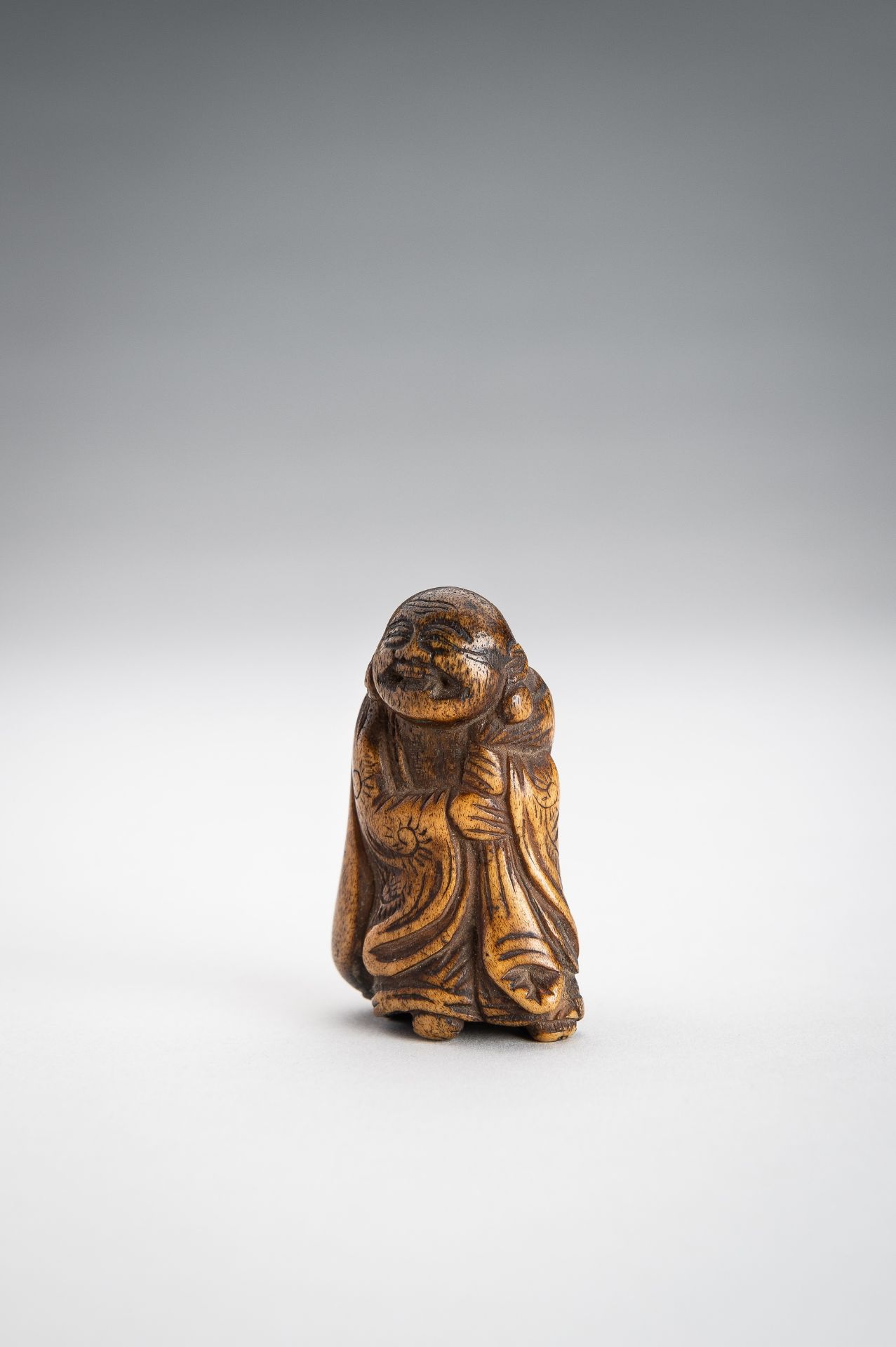 A STAG ANTLER NETSUKE OF HOTEI WITH HIS TREASURE BAG - Image 2 of 9