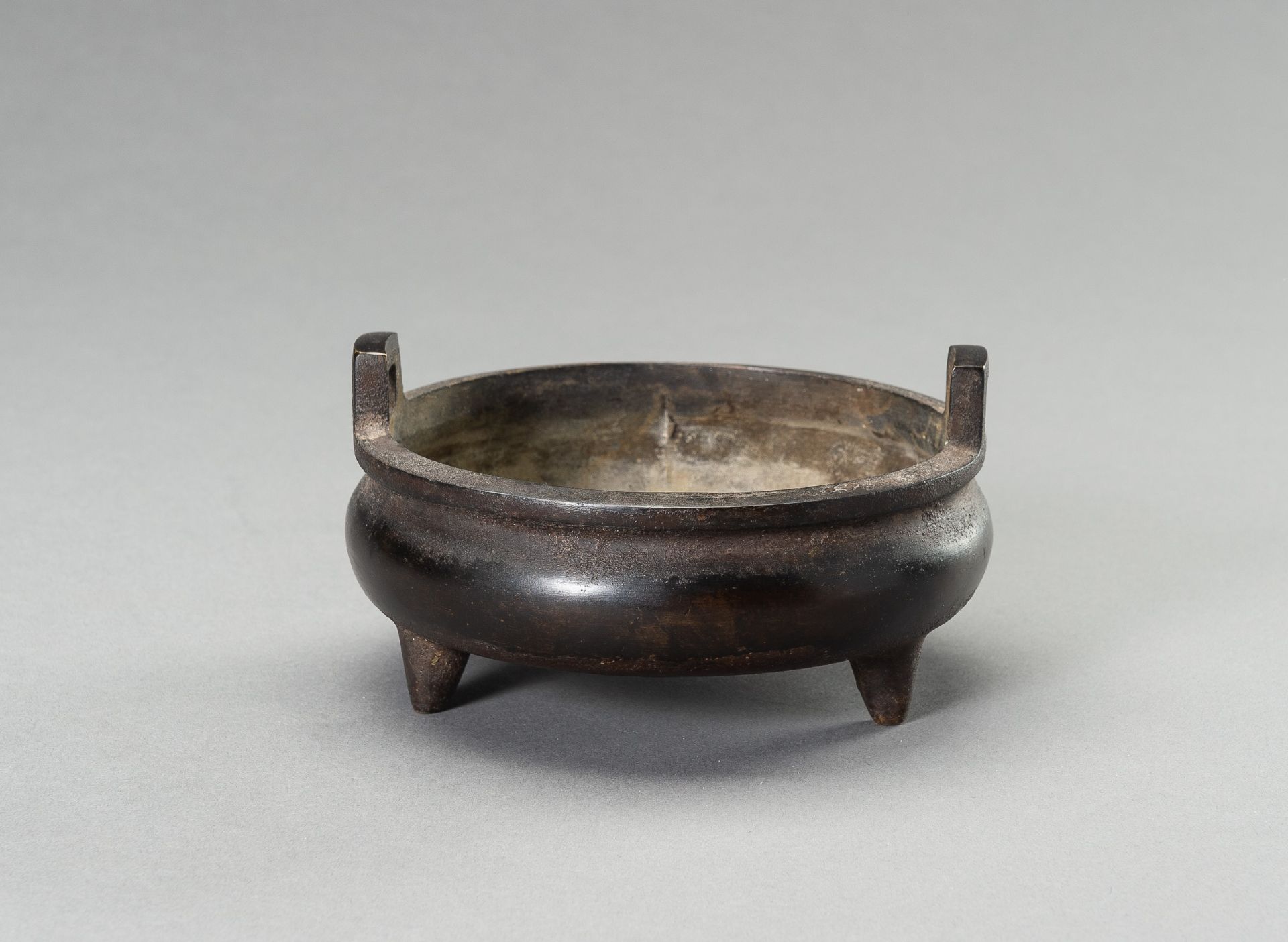 A BRONZE TRIPOD CENSER