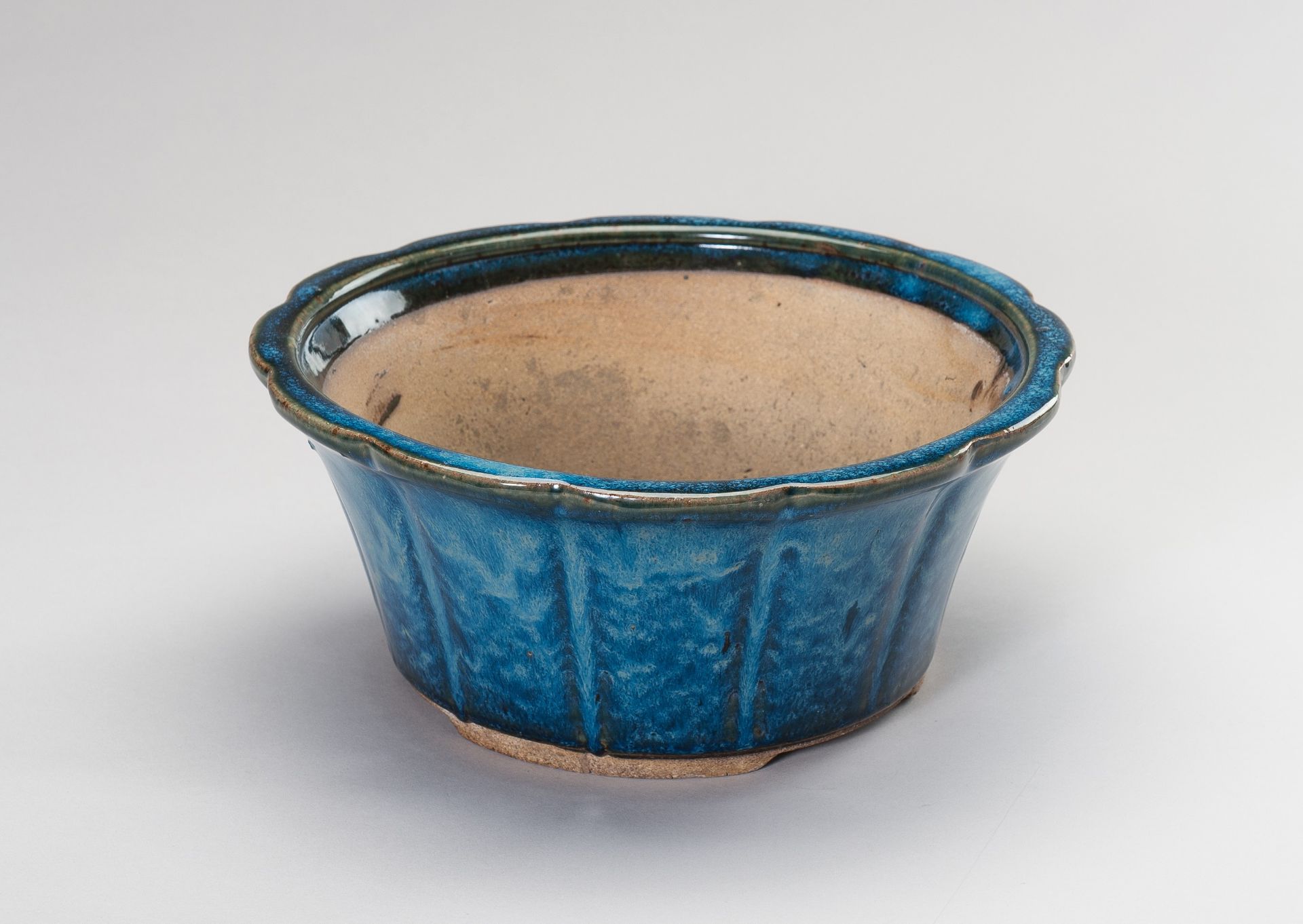 A FLAMBE-GLAZED CERAMIC CACHEPOT