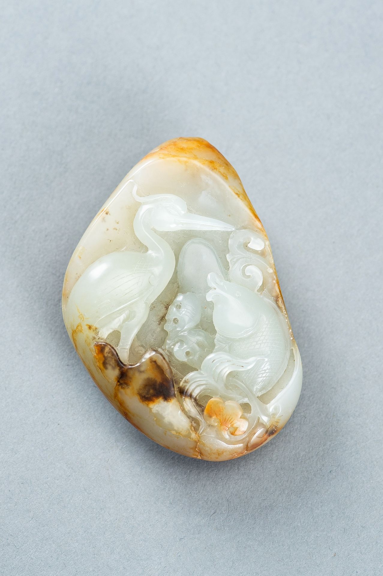 A CELADON AND RUSSET JADE 'FISH AND CRANE' PENDANT, c. 1920s - Image 2 of 9