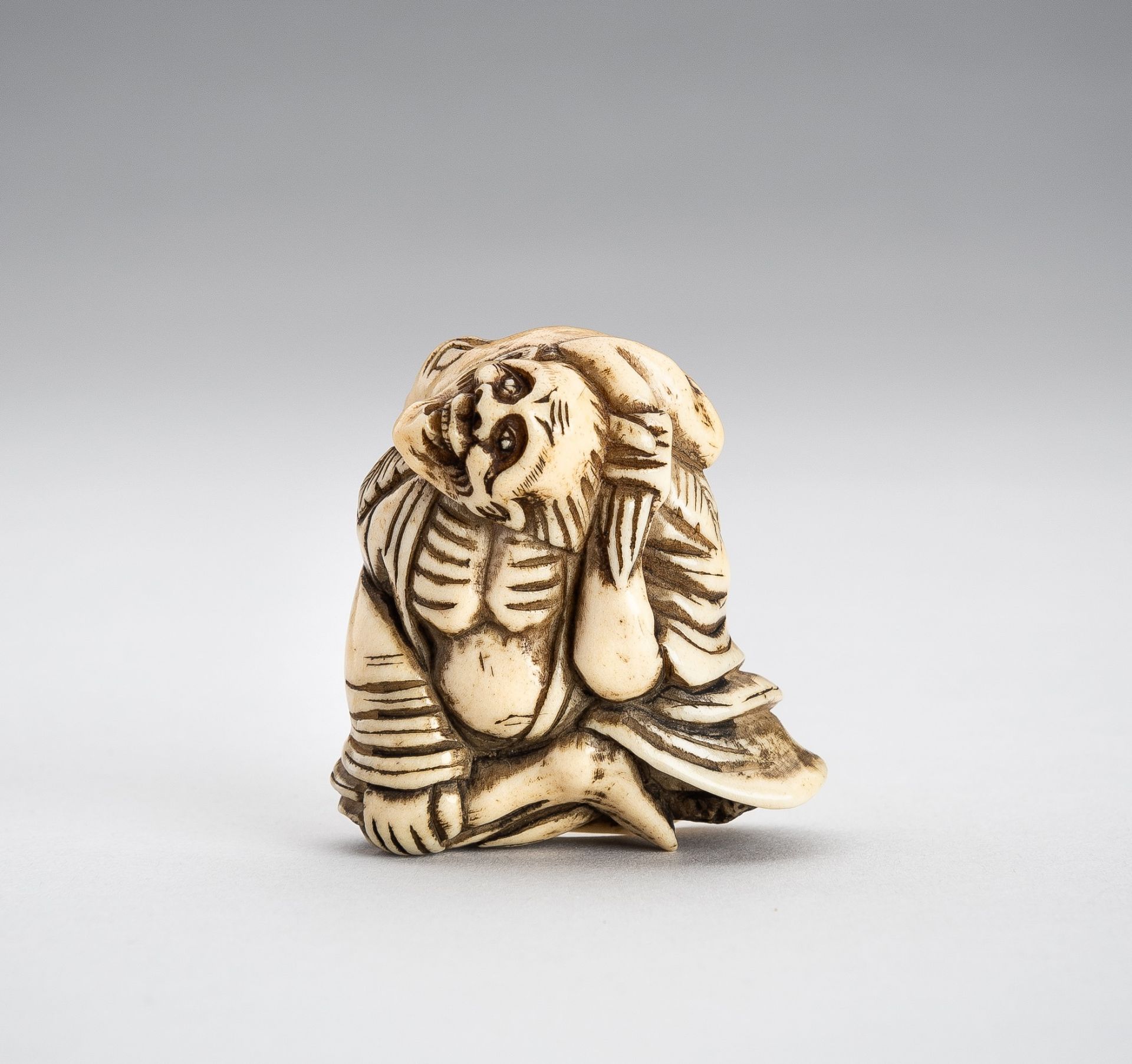 A STAG ANTLER NETSUKE OF GAMA SENNIN