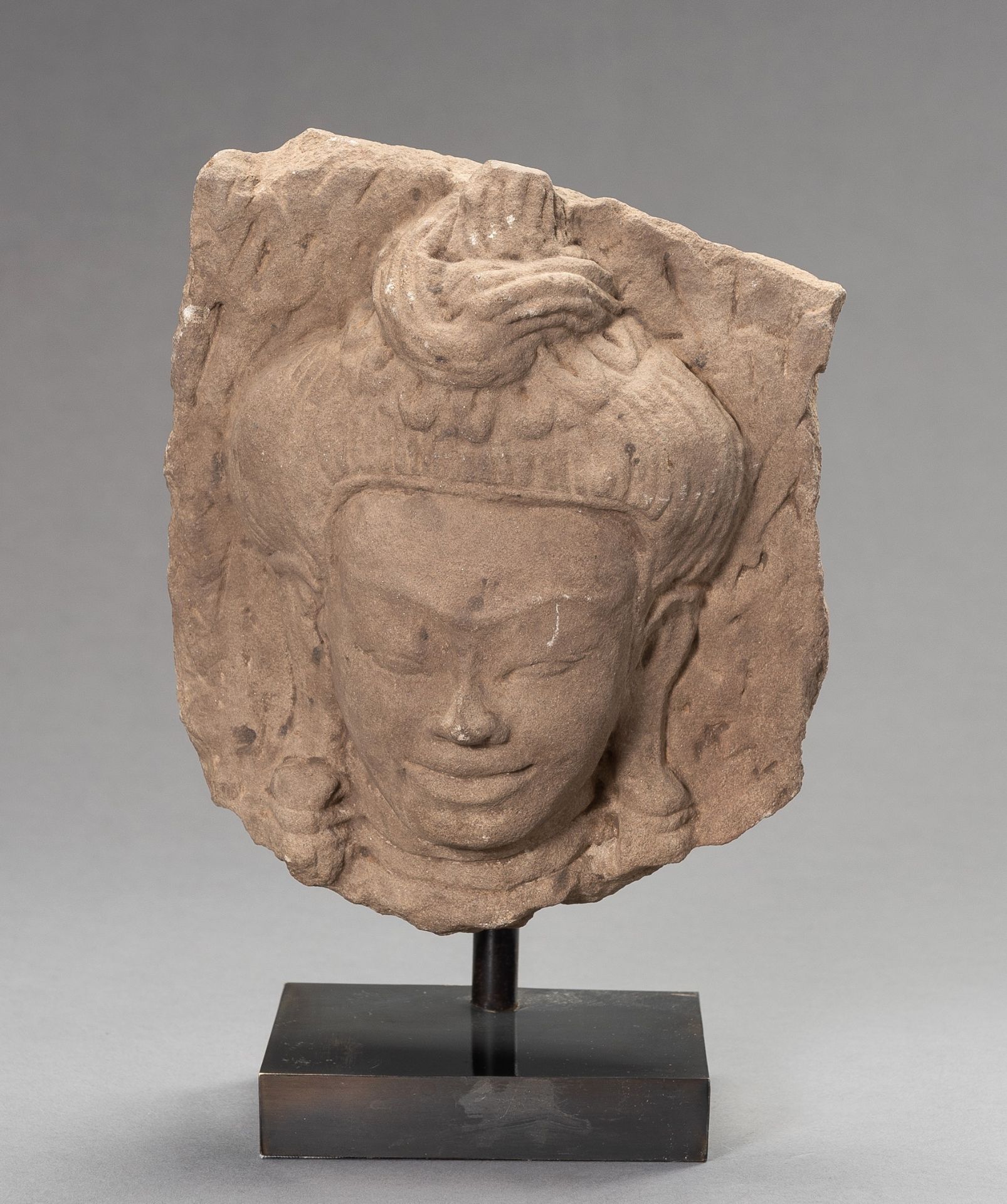 A SANDTONE FRAGMENT OF AN APSARA, BAYON STYLE, ANGKOR PERIOD