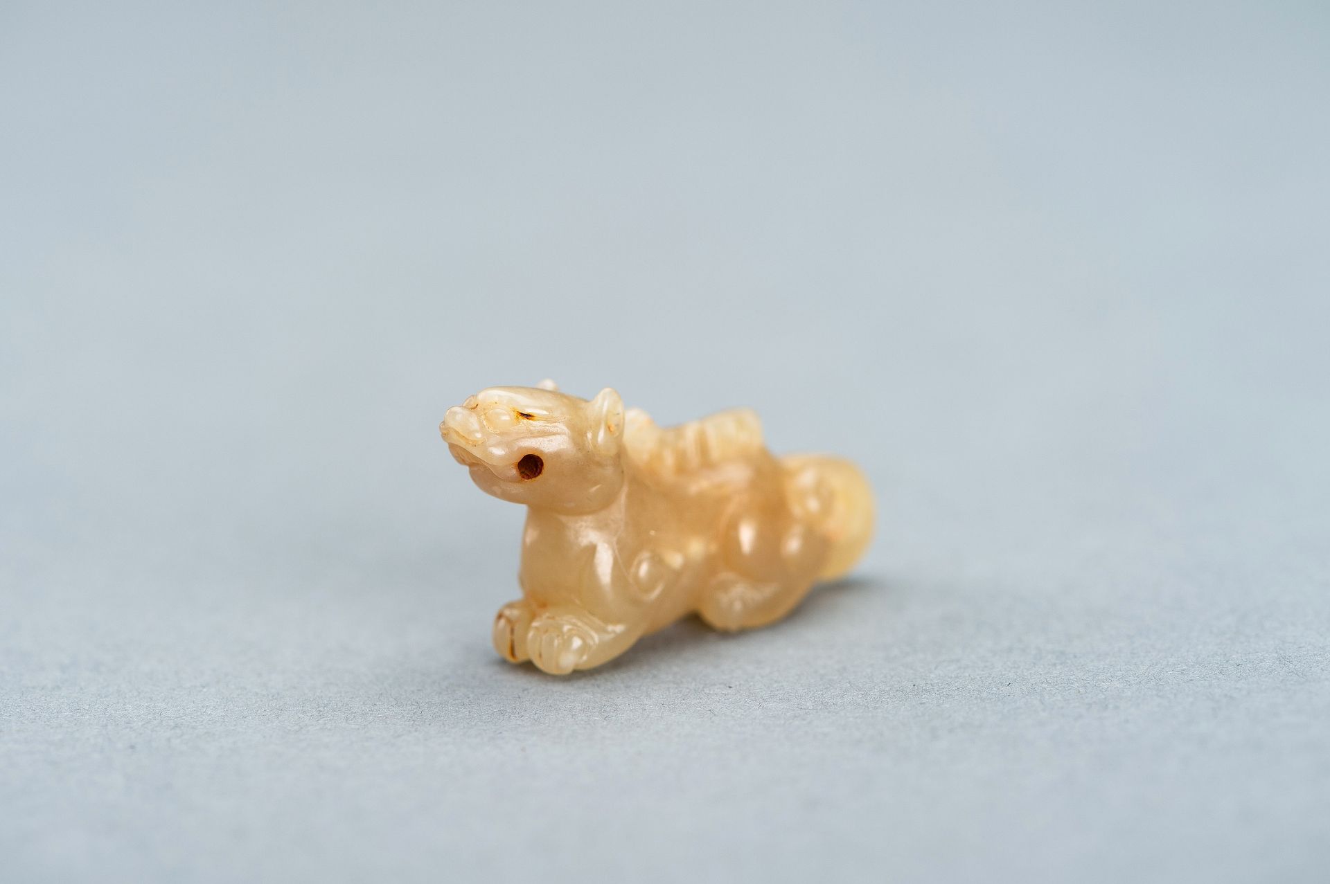 A PALE GREEN MINIATURE CARVING OF A LION, c. 1920s - Image 9 of 13