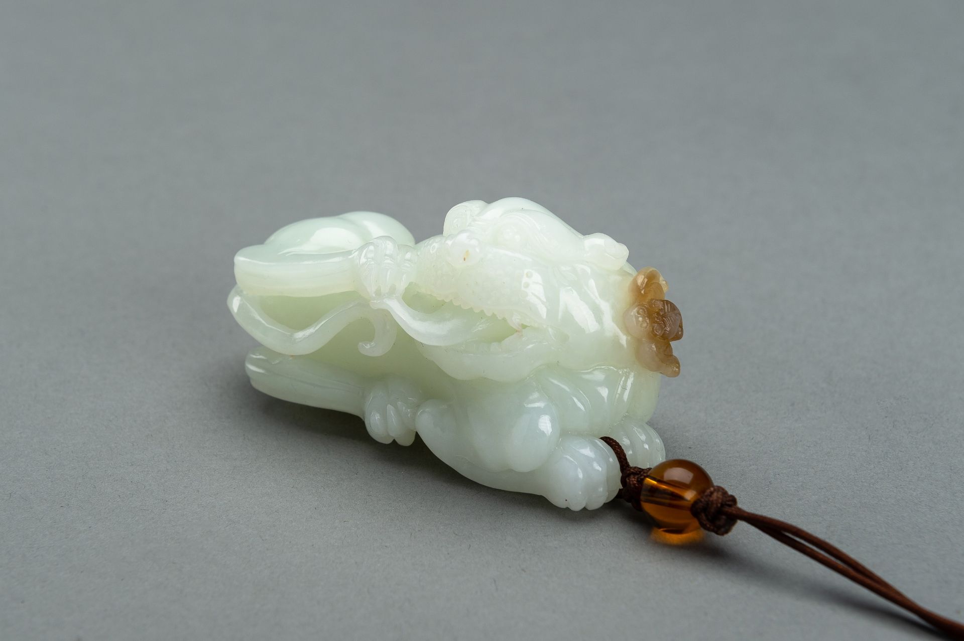 A WHITE JADE 'BUDDHIST LION AND BAT' CARVING, 1900s
