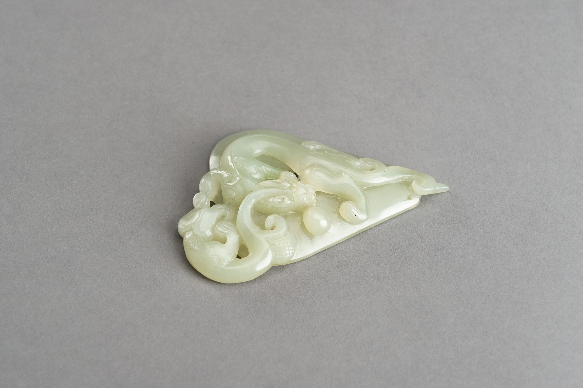 AN ARCHAISTIC PALE CELADON JADE PENDANT OF A CHILONG, 1920s - Image 10 of 14