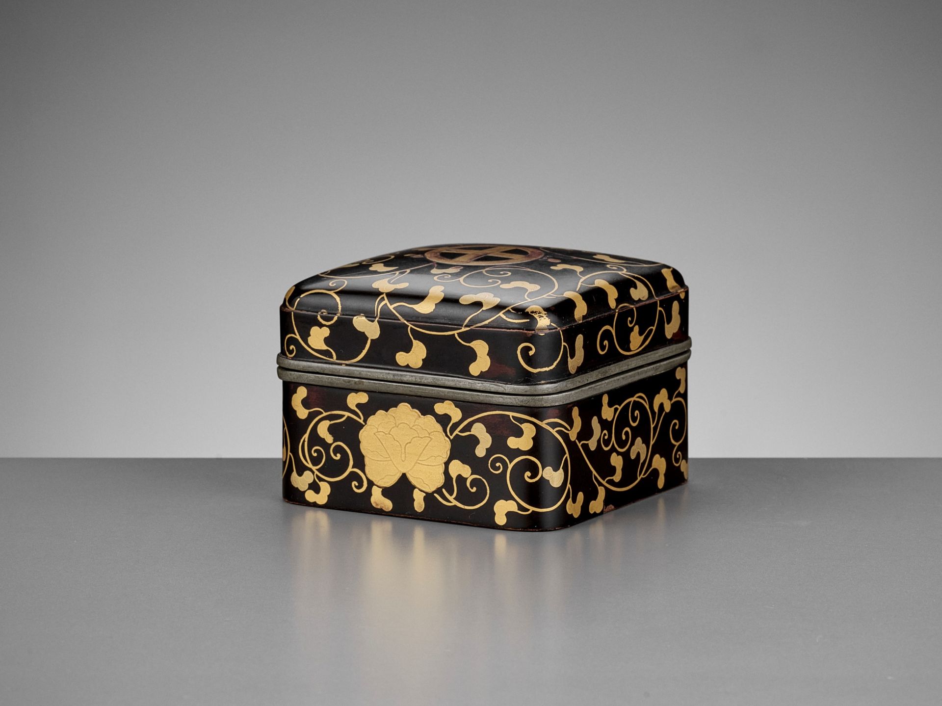 A RARE BLACK AND GOLD-LACQUERED KOBAKO AND COVER WITH SHIMAZU MONS