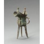 AN ARCHAISTIC SHANG-STYLE BRONZE RITUAL TRIPOD WINE VESSEL, JUE