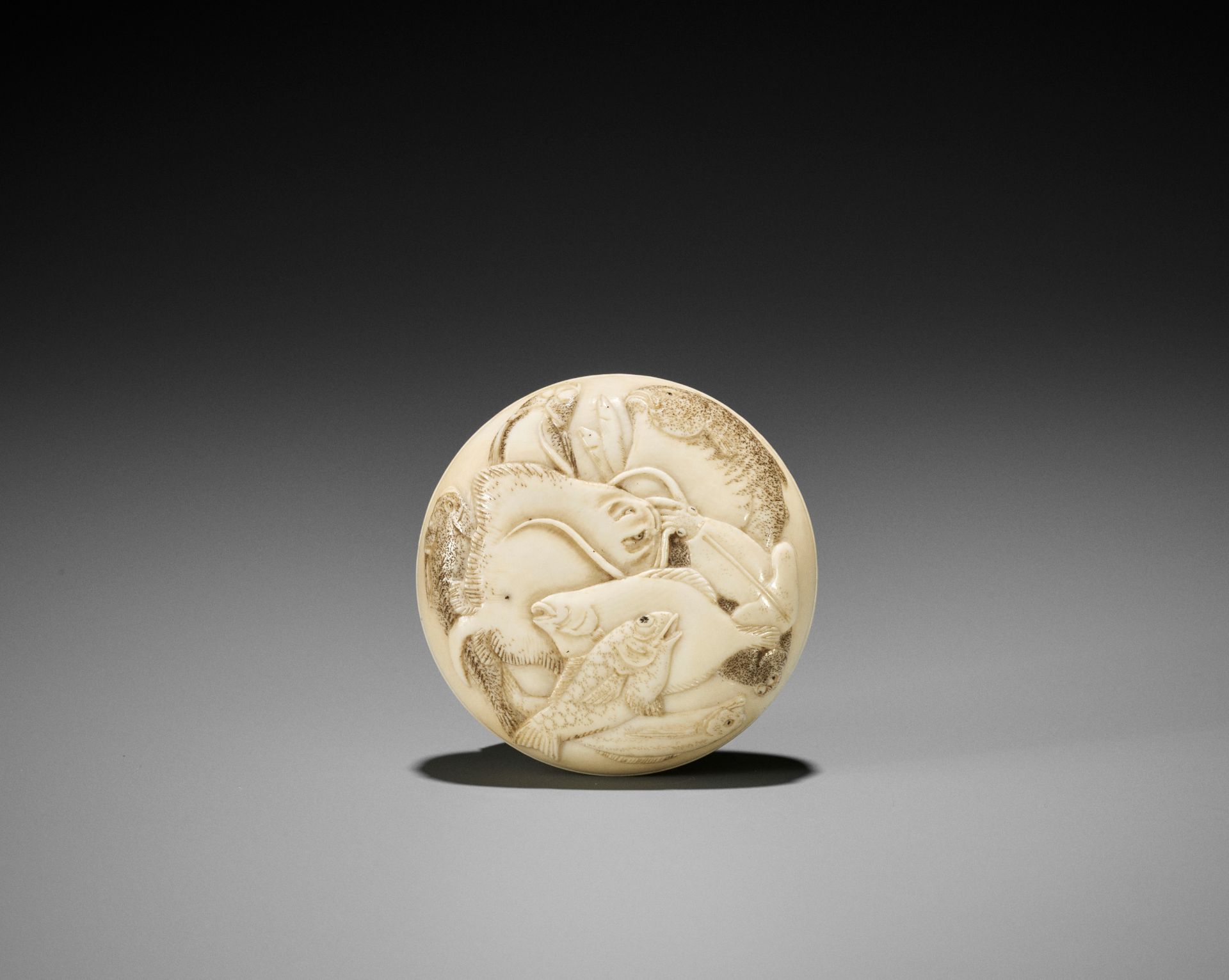 KEIMIN: A FINE IVORY MANJU NETSUKE OF MARINE LIFE