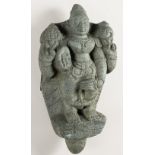 A LARGE INDIAN STONE STATUE OF A DEITY